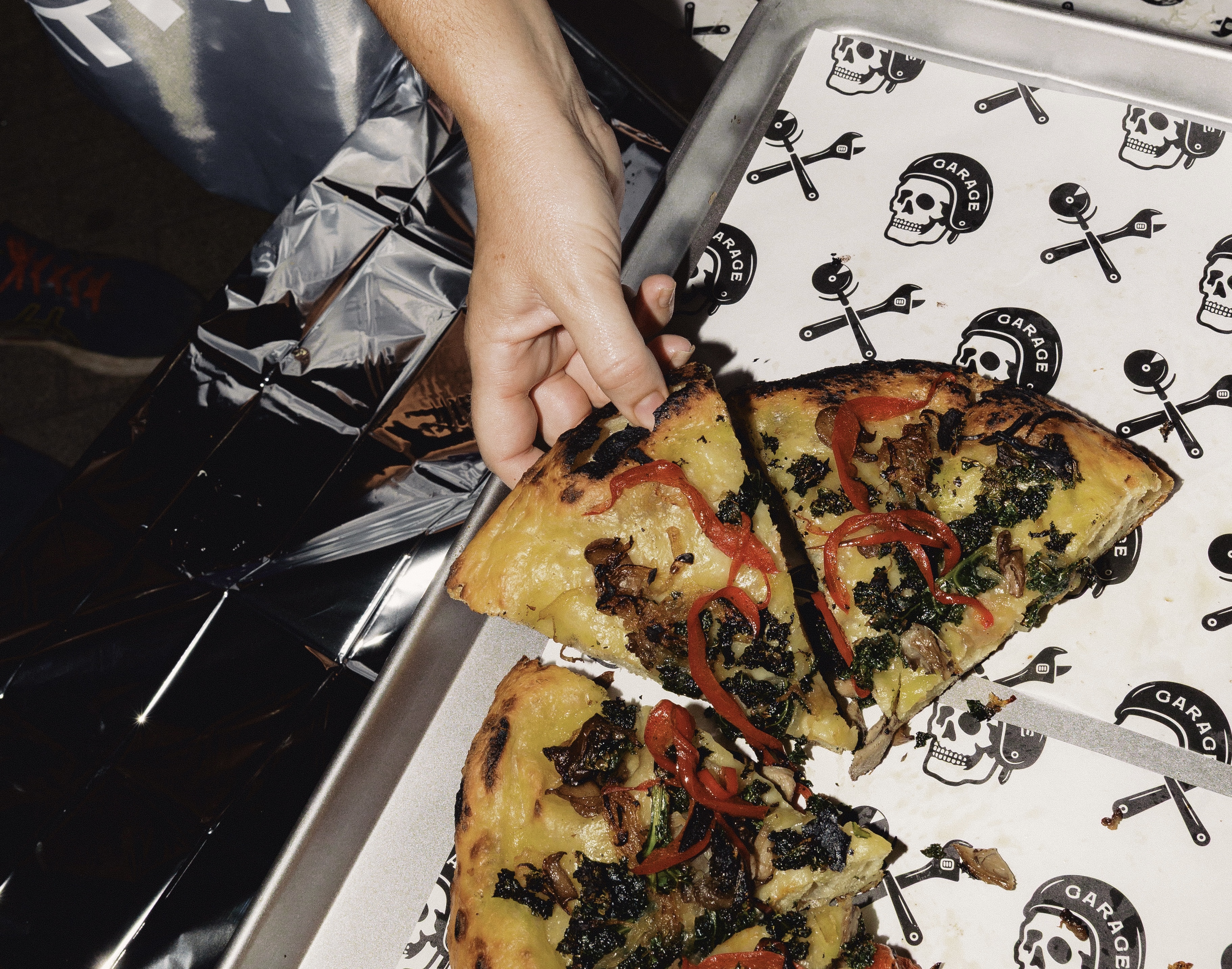 Garage Pizza ATX, Sicilian slice on branded paper